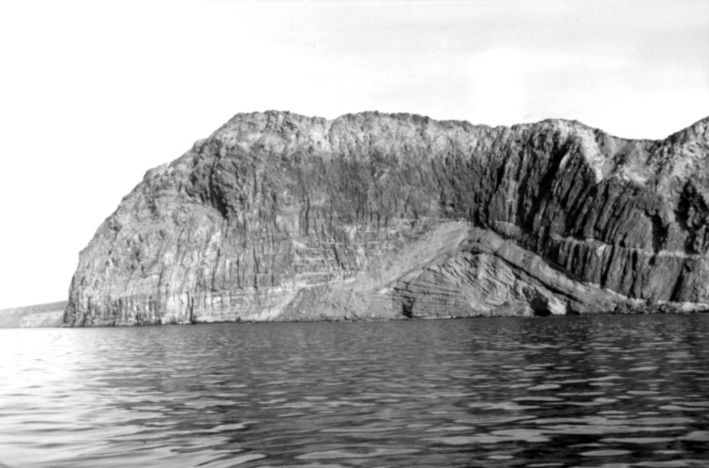 Steep cliffs forming across the southern end of Guadalupe Island expose thick lava flows that buried bedded pyroclastic units to the lower right.  Photo by Al Segel, 1963 (courtesy of Rodey Batiza, University of Hawaii).