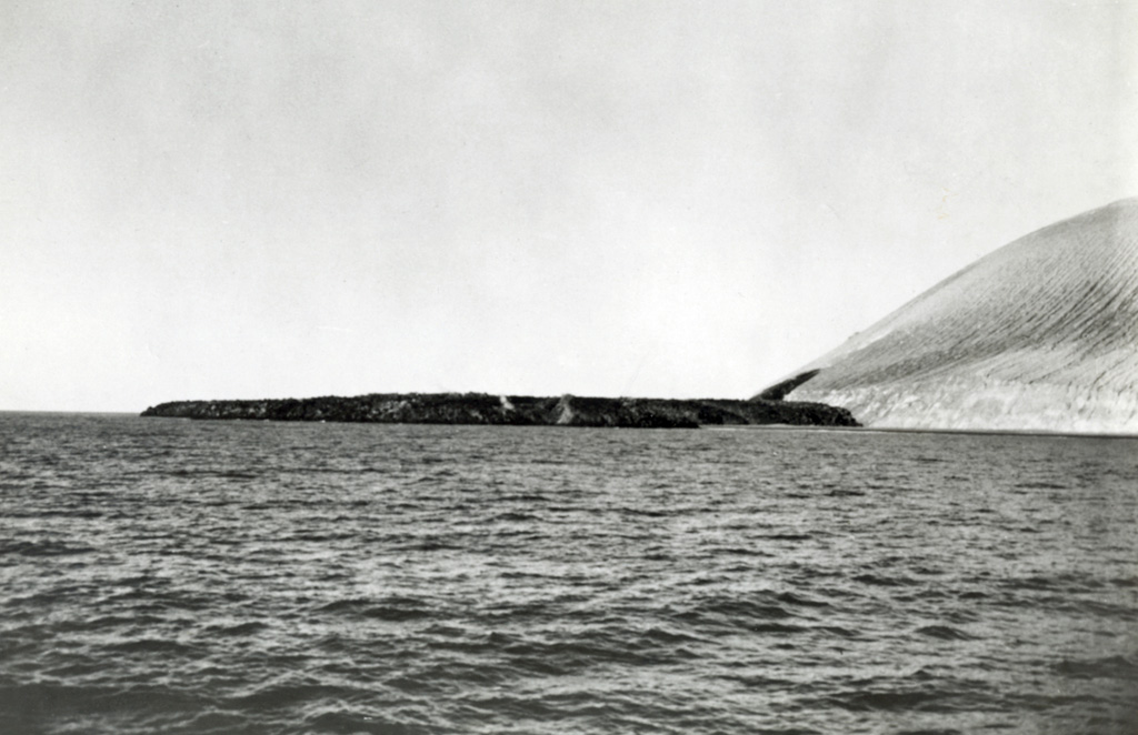 This lava delta formed during the 1952-53 eruption, seen here from the NE. The Delta Lávico flow extended 700 m out to sea on the SE side of Isla San Benedicto and formed a peninsula about 1.2 km wide. The lava can be seen extruding from the vent on the lower SE flank. The eruption began on 8 December and by the following morning the lava flow had reached the coast. Lava effusion continued into February 1953. Photo by U.S. Navy, 1952 (courtesy of Sherman Neuschel, U.S. Geological Survey).