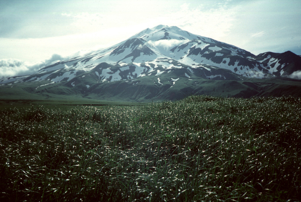 Pyre Peak was constructed within a 3-km-wide caldera and is seen from near the western tip of Seguam Island. The 11.5 x 24 km island contains two calderas, each with a Holocene cone. A third Holocene cone is at the eastern end of the island. The cone rises 1 km above the caldera floor and has been the source of many of the historical eruptions. Photo by Steve Ebbert, 1996 (U.S. Fish and Wildlife Service).