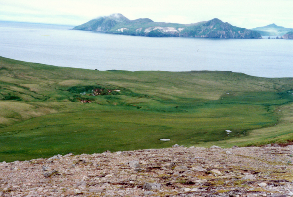 Davidof Island is seen here across the strait from the western side of Little Sitkin Island. Five small islands, the largest of which is Davidof, are remnants of a volcano that collapsed during the late Tertiary to form a 2.7-km-wide caldera. The islands include Khvostof (top-right horizon), Pyramid, Lopy, and Davidof. The latter three islands form the eastern rim of the caldera. Photo by Steve Ebbert, 2000 (U.S. Fish and Wildlife Service).