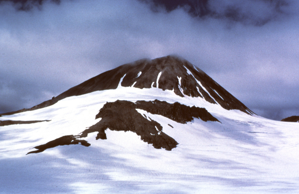 The SE side of a Holocene dome at Kialagvik rises 350 m above a surrounding glacier. It lies at the NE end of a segment of the Alaska Peninsula that includes neighboring Chiginagak and Yantarni volcanoes. Lava flows and overlying block-and-ash-flow deposits are exposed on the SW flank and in a small area on the NE flank. Photo courtesy U.S. Geological Survey, Alaska Volcano Observatory.