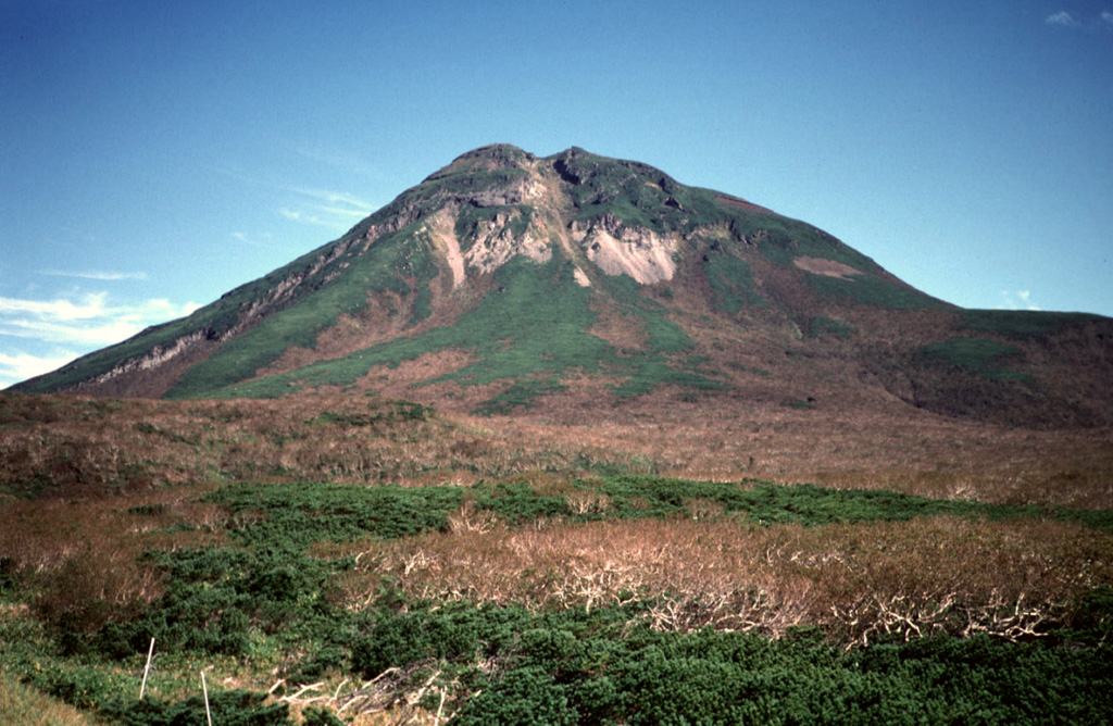 Rausudake, seen here from the SW at Shiretoko Pass, is a small cone in NE Hokkaido. It is located 5 km SW of Shiretoko-Iozan volcano along the crest of the elongated NE-trending ridge forming the Shiretoko Peninsula. Explosive eruptions have taken place several times during the Holocene, including eruptions of pumiceous tephras about 2,200 and 1,500 years ago. Copyrighted photo by Yoshihiko Goto (Japanese Quaternary Volcanoes database, RIODB, http://riodb02.ibase.aist.go.jp/strata/VOL_JP/EN/index.htm and Geol Surv Japan, AIST, http://www.gsj.jp/).