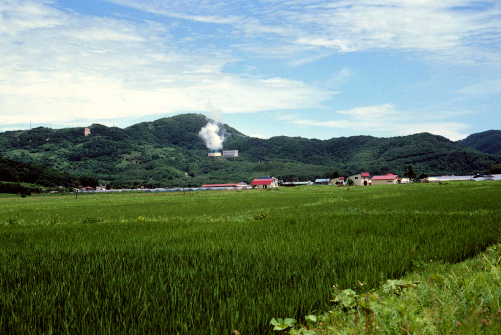 Steam rises from a geothermal plant on the N side of Nigorigawa caldera in SW Hokkaido. The caldera, located along the shores of Uchiura Bay WNW of Hokkaido-Komagatake volcano, formed during a major explosive eruption about 12,900 +/- 270 years ago. The flat caldera floor contains the town of Nigorigawa.  Copyrighed photo by Tadahide Ui (Japanese Quaternary Volcanoes database, RIODB, http://riodb02.ibase.aist.go.jp/strata/VOL_JP/EN/index.htm and Geol Surv Japan, AIST, http://www.gsj.jp/).