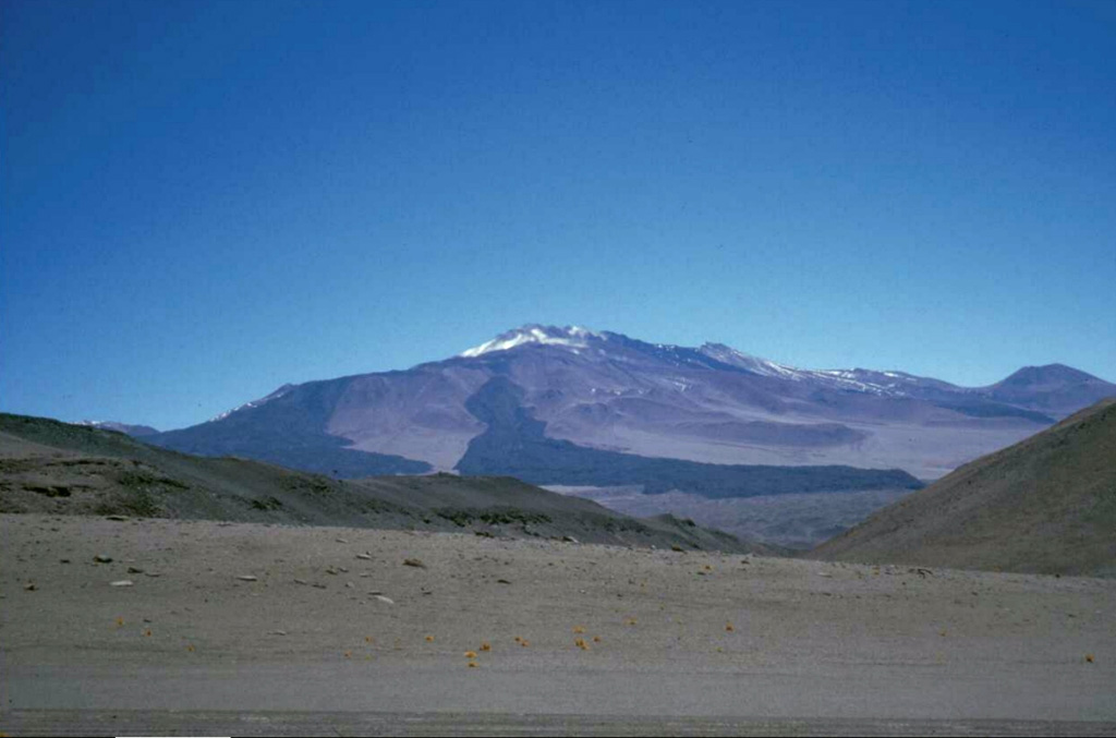 Fresh-looking lava flows drape the southern flanks of the compound volcano of Cerro el Cóndor, one of the few large stratovolcanoes located entirely in Argentina.  The summit complex lies within a 2.5-km-wide caldera and contains several ash cones and craters that have been the source of a number of pristine lava flows that have descended to beyond the flanks of the volcano.  The morphologically youthful lava flows and pristine summit crater imply a Holocene age.      Photo by Ben Edwards, 1998 (Dickinson College, Pennsylvania).