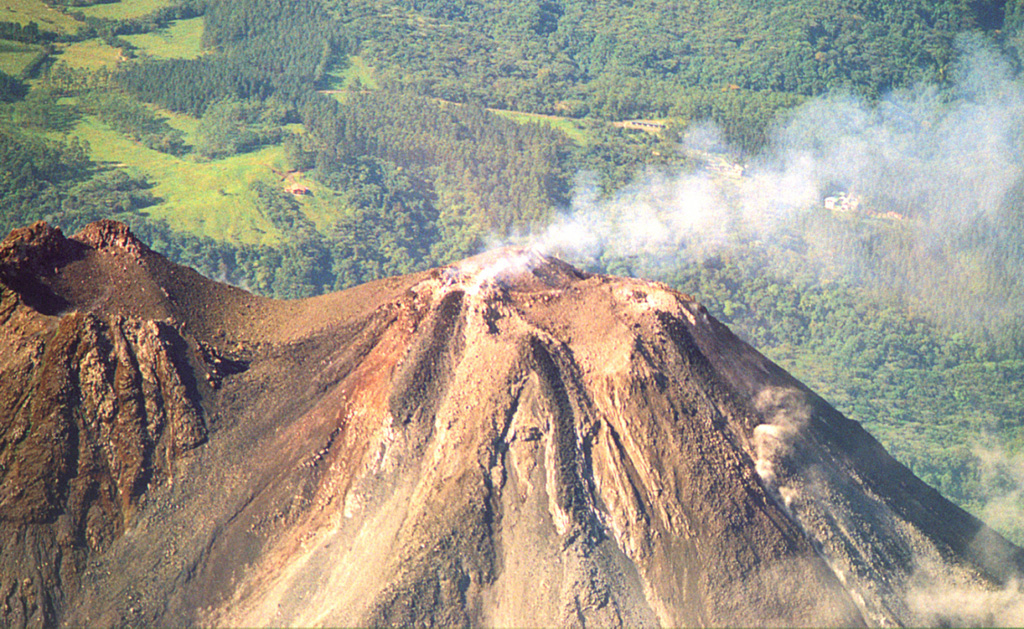 This May 2001 photo shows a gas plume bring dispersed to the west from Crater C, the most recent active summit crater of Arenal. A small saddle separates Crater C from Crater D (left margin), the vent of a major explosive eruption that occurred around 1530 CE. Photo by Federico Chavarria Kopper, 2001.