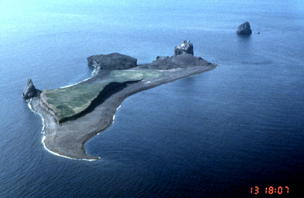 Lava dome remnants from four historical eruptions can be seen in this NW-looking aerial view of Bogoslof in the Aleutians. The pinnacle to the left is Castle Rock, a remnant of a 1796 lava dome. The circular, flat-topped area to its right is a remnant of a 1927 lava dome. An eruption in 1992 produced the light-colored rounded lava dome forming upper right part of the island. The island to the upper right formed in 1883. Photo by John Sease, 1998 (NMS/NOAA).