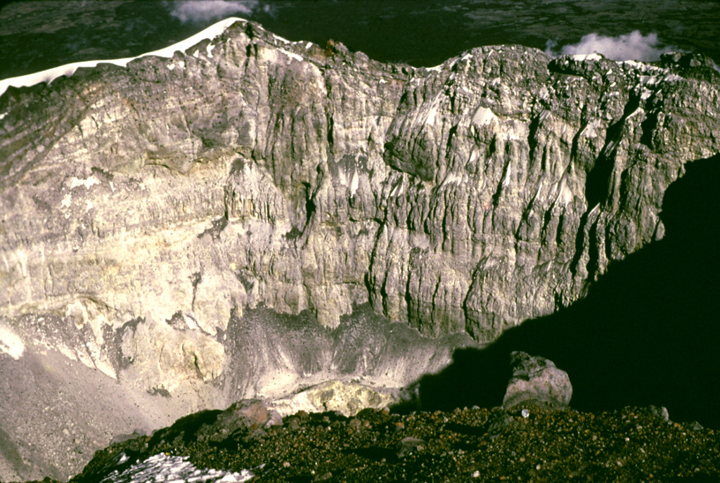 The steep crater wall of Popocatépetl is seen here from the western crater rim 1979 showing the stratigraphy of the upper cone. The low point on the eastern crater rim is about 170 m below the summit. Photo by Bob Luhr, 1979.