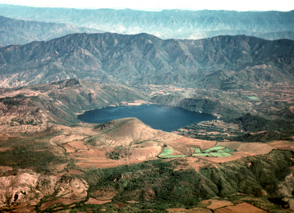 The scenic lake-filled Santa María del Oro maar was erupted through older Miocene rhyolitic tuffs of the Sierra Madre Occidental.  The lake is seen here from the NW, with the large ridge behind it forming the axis of a large fold affecting the Miocene ashflow tuff deposits.  The southern rim of the maar is reached by a road from the town of Santa María del Oro (right center).  The peaks on the northern rim of the roughly 3-km-wide maar rise about 400 m above the Laguna Santa María crater lake.   Photo by Jim Luhr, 1979 (Smithsonian Institution).