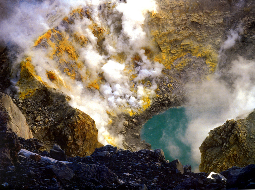 Gas and steam emit from fumaroles on the sulfur-encrusted crater wall of Popocatépetl seen here in 1993, prior to the eruptive activity that began in December 1994. The east floor of the crater contained a smaller circular crater about 200 m in diameter and 50 m deep. A small lake about 40 m in diameter and 10 m deep, which varied in size seasonally, contained warm water (29°C) in 1986. By February 1994 the lake temperature had risen to 65°C. Photo by Hugo Delgado-Granados, 1993 (Universidad Nacional Autónoma de México).