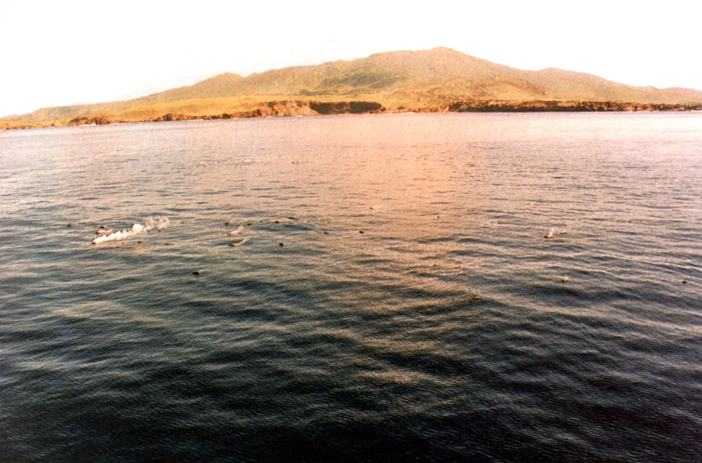 Trails of steam in the foreground rise from floating scoriaceous clasts during a submarine eruption off the west coast of Socorro Island in 1993. The eruption, from vents about 3 km NW of Punta Tosca, was first observed 29 January 1993 following ten days of SOFAR (SOund Fixing And Ranging) signals recorded in Hawaii. Large scoriaceous clasts up to 5 m in size floated to the surface without associated explosive activity. Floating masses of hot scoria were erupted until at least the end of February 1994. Photo by Hugo Delgado-Granados, 1993 (Universidad Nacional Autónoma de México).