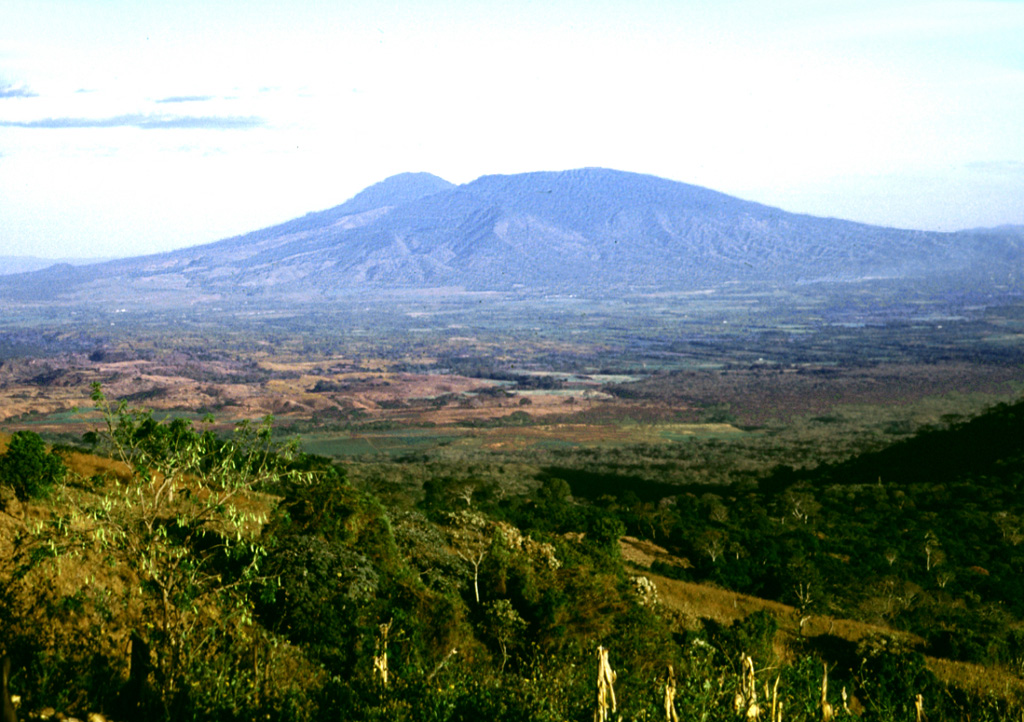 This view from the southern rim of Coatepeque shows the western side of San Salvador volcano. The broad Boquerón edifice has grown within a large crater within an older stratovolcano, of which rounded Picacho to the left is a remnant. The flat brown-colored area to the right is the 1722 lava flow from San Marcelino scoria cone on the lower flank of Santa Ana. Photo by Lee Siebert, 2002 (Smithsonian Institution).