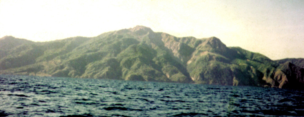 An unvegetated lava dome is visible at the summit of Paluweh. The massif forms an 8-km-wide island located N of the volcanic arc that includes Flores Island. The summit region contains overlapping craters and lava domes, and several flank vents occur along a NW-trend. Multiple eruptions have occurred through historical time. Photo by Volcanological Survey of Indonesia.