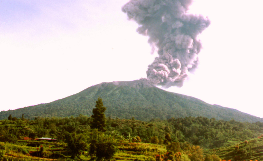 An ash plume rises from the summit crater of Marapi volcano in this undated photo, perhaps from the late 1980s or early 1990s. Marapi produces frequent small-to-moderate explosive eruptions that have been recorded since the 18th century. Photo by Igan Sutawidjaja (Volcanological Survey of Indonesia).