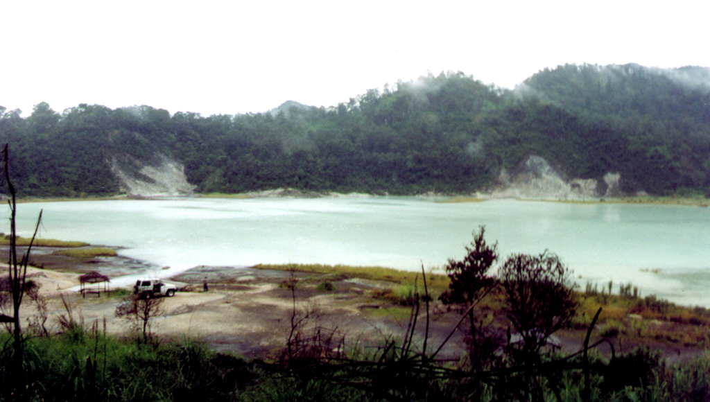 A monitoring team from the Volcanological Survey of Indonesia visits Talagabodas, located immediately N of Galunggung volcano. The crater contains this large sulfur-saturated lake. Fumaroles, mud pots, and a warm spring are found around the 400-500 m wide lake, which also has an elevated temperature. Changes in lake color occurred in 1913 and 1921, and expanded solfatara activity was reported in 1927. Photo by Igan Sutawidjaja (Volcanological Survey of Indonesia).