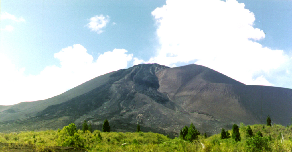 The small Soputan stratovolcano, seen here from the west, was constructed on the southern rim of the Quaternary Tondano caldera in northern Sulawesi Island.  The youthful, largely unvegetated Soputan volcano  is one of Sulawesi's most active volcanoes.  During historical time the locus of eruptions has included both the summit crater and Aeseput, a prominent NE flank vent that formed in 1906 and was the source of intermittent major lava flows until 1924.     Photo by Agus Solihin (Volcanological Survey of Indonesia).