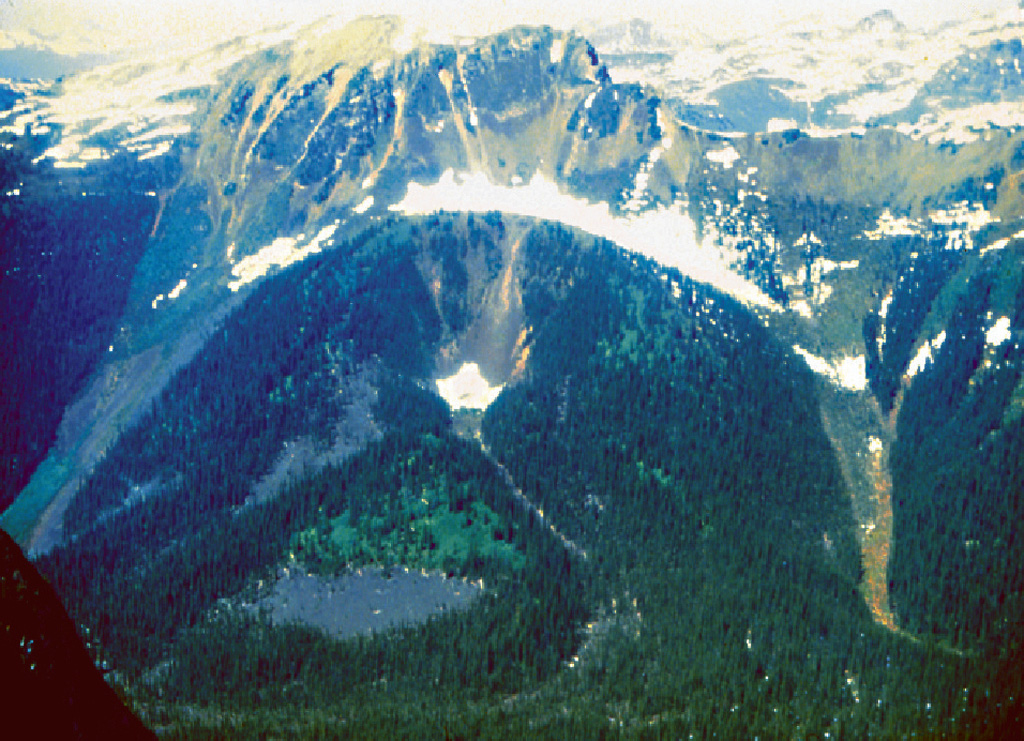 The Wells Gray-Clearwater volcanic field in the Quesnel Highland of east-central British Columbia contains basaltic cones and lava flows of early Pleistocene-to-Holocene age. Dragon Cone (above) produced lava flows that traveled 14 km down Falls Creek to the Clearwater River. Pleistocene deposits include plateau-capping lava flows, subglacial mounds and tuyas, and hyaloclastites. Several cones were active during the Holocene, and the latest eruption took place from Kostal cone about 400 years ago. Photo by Cathie Hickson (Geological Survey of Canada).