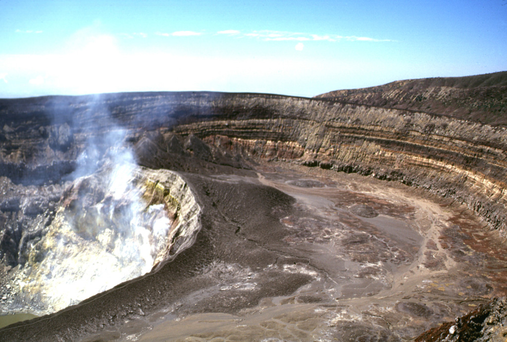 Several nested craters are found at the summit of Santa Ana. Gases rise from fumaroles on the steep NE wall of an inner crater, within a roughly 900-m-wide crater. The 80-m-high crater walls expose tephra layers from phreatomagmatic eruptions. The walls of the two outer craters, which open towards the SW, are at the upper right. Photo by Lee Siebert, 2002 (Smithsonian Institution).