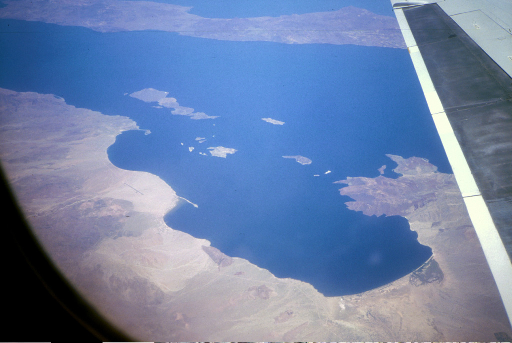 An aerial view from the SW overlooks the Bay of Los Angeles in the foreground in the east-central part of Baja California. Isla Coronado is the largest of the islands in this view with Volcán Coronado at the northern end of the island. Angel de la Guarda Island extends across the top of the photo. Photo by Brian Hausback, 1996 (California State University, Sacramento).