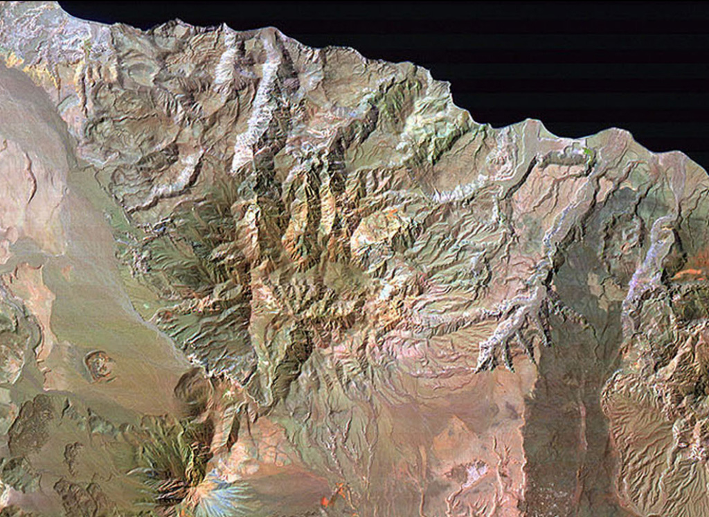 El Aguajito caldera is located along the Gulf of California immediately NE of Tres Vírgenes volcano (lower left) and NW of La Reforma caldera (partially visible at the right).  The approximately 10-km-wide caldera covers the broad dissected area from Tres Vírgenes to the sea.  The rim of the mid-Pleistocene caldera is not exposed, but an arcuate line of andesitic-to-rhyolitic lava domes lies along its northern margin.  Hot springs are located along the southern caldera margin in the linear NW-trending valley between the caldera and Tres Vírgenes. NASA Landsat image (processed by Brian Hausback, UC Sacramento).