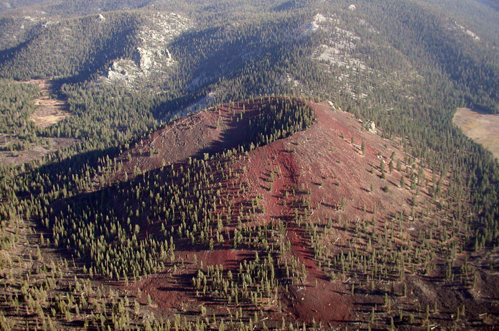 Groundhog cinder cone, the youngest of the Golden Trout Creek volcanic field, is breached to the NE.  Groundhog cone was the source of a Holocene lava flow that traveled 6 km to the west down Golden Trout Creek  The volcanic field consists of a group of Quaternary alkali olivine basaltic cinder cones and lava flows in the Sierra Nevada about 25 km south of Mount Whitney.  Lava flows erupted through light-colored Mesozoic granitic rocks of the Sierra Nevada batholith visible behind Groundhog cone and on its upper right side. Photo by Rick Howard, 2002 (courtesy of Del Hubbs, U S Forest Service).
