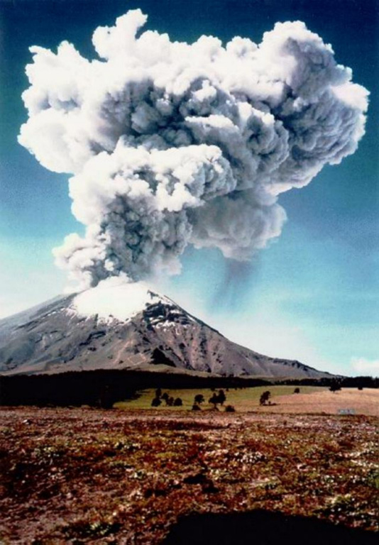 An ash plume towers above Popocatépetl as viewed from Paso de Cortés NW of the volcano at 1032 on 11 June 1997. The photo was taken 18 minutes after a 15-minute-long volcanic tremor episode that accompanied the major ash emission, which reached an altitude of 4 km above the summit. Intermittent ash emission had begun on 5 March 1996, some of which produced ashfall that reached the Gulf of Mexico. This activity was accompanied by periodic growth and destruction of lava domes in the summit crater. Photo courtesy CENAPRED, Mexico City, 1997.
