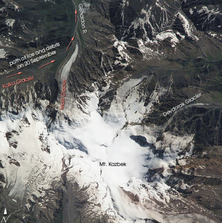 The glacier-covered Kazbek stratovolcano, the second highest in the Caucasus Mountains of Georgia, lies just south of the border with Russia. The summit cone and the most recent lava flows are of postglacial age, and the latest andesitic-dacitic lava flow was radiocarbon dated at about 6,000 years ago. Arrows at the top left on this 13 August 2002 NASA Space Shuttle image mark the path of an avalanche and debris flow produced by collapse of a glacier the following month. Image courtesy of Earth Sciences and Image Analysis Laboratory, NASA Johnson Space Center, 2002 (http://eol.jsc.nasa.gov).