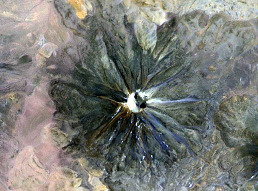 An ASTER satellite image from NASA in November 2000 looks down onto the summit crater of Chilques volcano.  Radial gullies descend the flank of the volcano.  Nighttime thermal infrared images on April 12, 2002 revealed hot spots in the summit crater and along the upper flanks, marking the first observations of historical activity at the volcano.  
 NASA ASTER image, 2000 (http://eol.jsc.nasa.gov/).