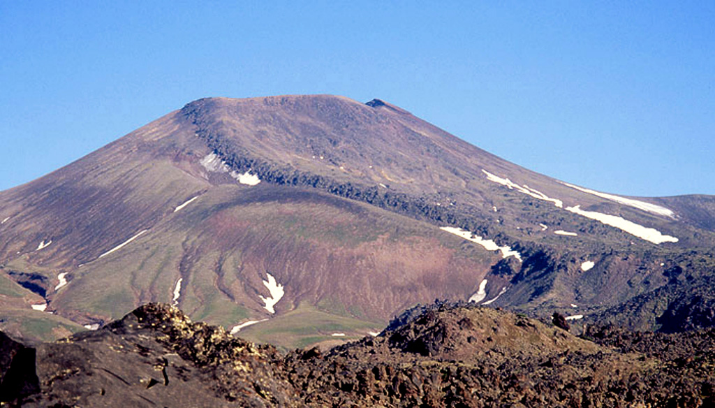 A broad lava flow descends from the summit crater down the southern flank of Vysoky, which is located about 4 km NE of Komarov. It has been active from the beginning of the Holocene and the lava flow was produced at least about 2,000 radiocarbon years ago. Copyrighted photo by Vera Ponomareva (Holocene Kamchataka volcanoes; http://www.kscnet.ru/ivs/volcanoes/holocene/main/main.htm).