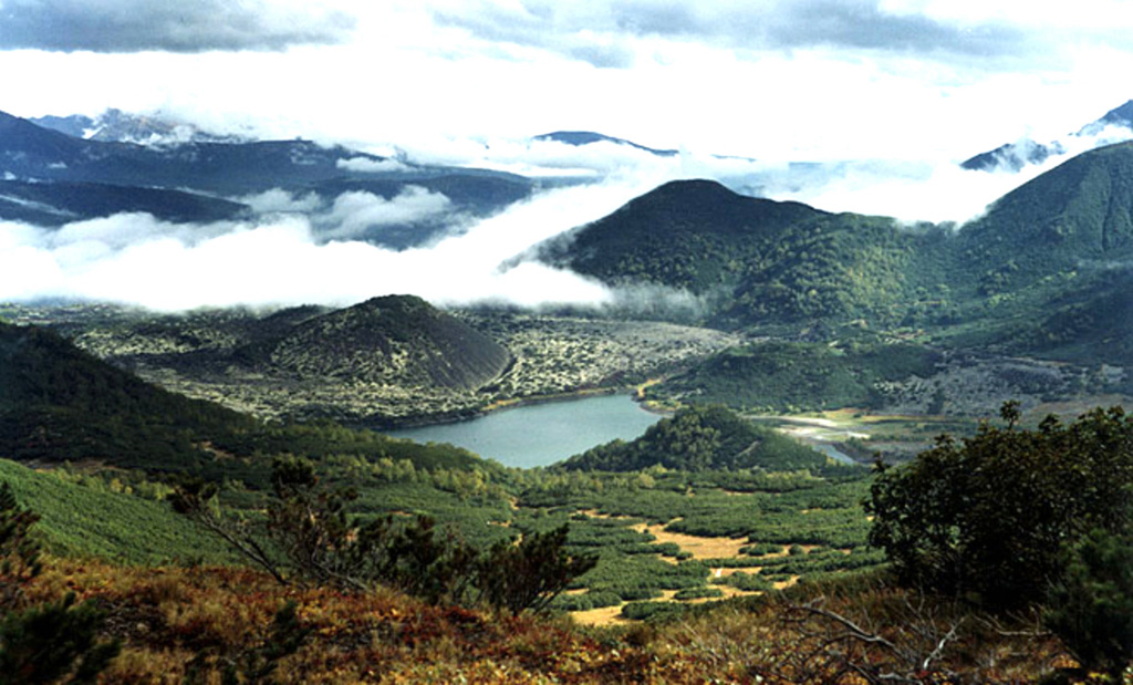 A N-S-trending chain of scoria cones lies in the Kostakan valley south of Bakening volcano. The 600-year-old Glavny scoria cone (left center) is surrounded by its lava flow, which dammed a small river to form beautiful Kostakan lake. Two small vegetated early Holocene cones lie along the opposite side of the lake.  Copyrighted photo by Sergei Konyaev (Holocene Kamchataka volcanoes; http://www.kscnet.ru/ivs/volcanoes/holocene/main/main.htm).