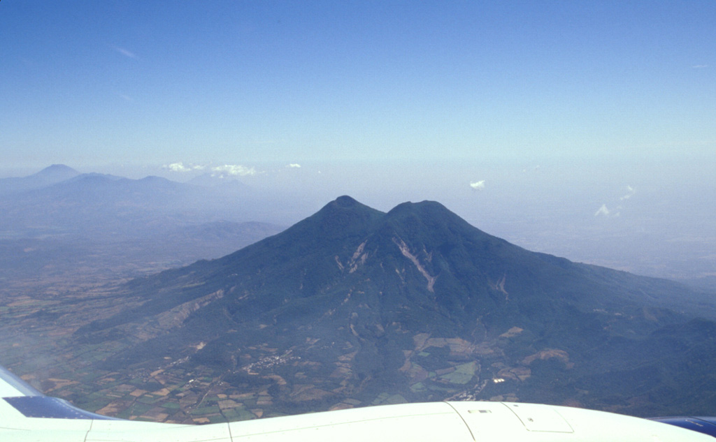 Flights from the international airport at San Salvador often pass close to San Vicente volcano, seen here from the south. The edifice is within the La Carbonera caldera, which formed during a major Plinian explosive eruption during the Pleistocene. Photo by Paul Kimberly, 2002 (Smithsonian Institution).