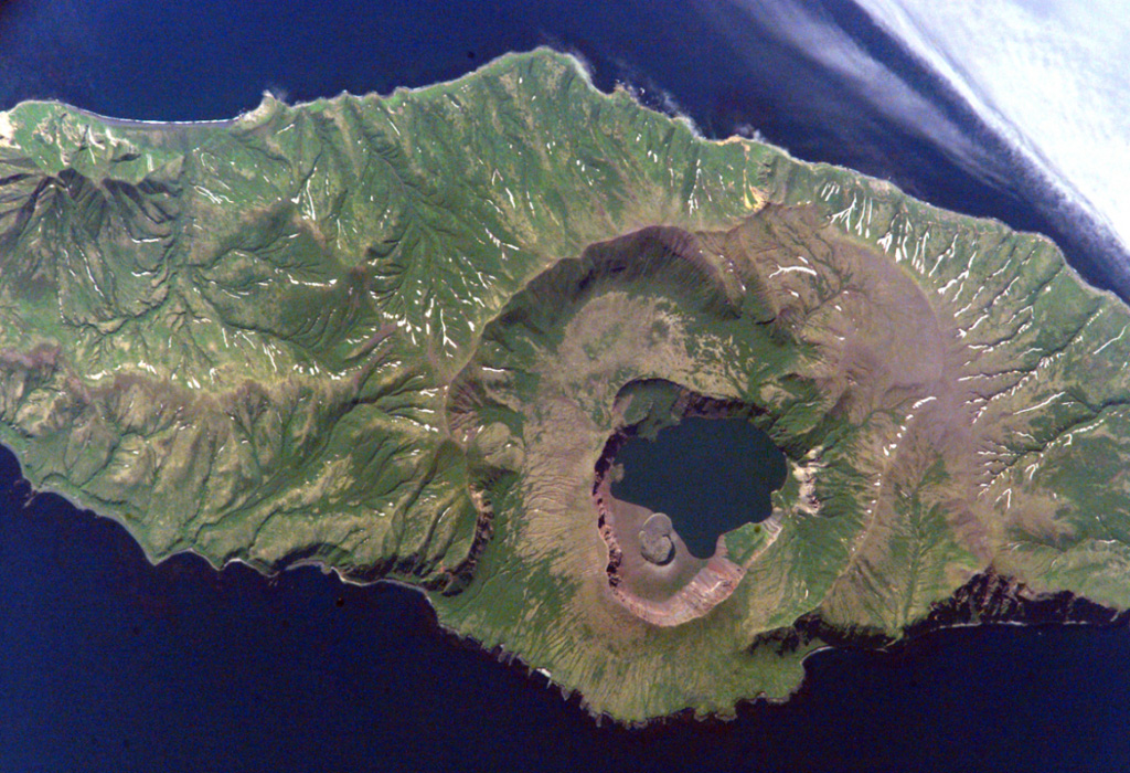 Biryuzovoe lake partially fills the youngest of three nested calderas of Zavaritzki volcano in central Simushir Island. The largest caldera is 10 km wide. The surface of the lake in the youngest 3-km-wide caldera is at about 40 m elevation and its bottom lies about 30 m below sea level. The lava below the lower side of the lake in this International Space Station view (N is to the lower left) was emplaced during a 1957 eruption. NASA International Space Station image ISS005-E-6512, 2002 (http://eol.jsc.nasa.gov/).