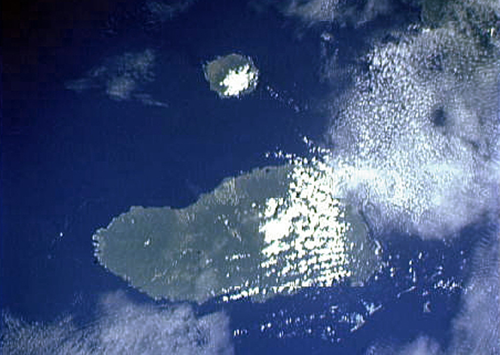 The small circular island at the top-center is Sakar, the NE-most of a chain of volcanic islands off the northern coast of Papua New Guinea. The 8 x 10 km wide island, seen in this Space Shuttle image with north to the upper left, is an incised stratovolcano with a summit crater lake. The 50-km-wide island of Umboi, whose left side is cut by a large caldera breached to the NE, fills the center of the image. NASA Space Shuttle image STS50-100-D, 1992 (http://eol.jsc.nasa.gov/).
