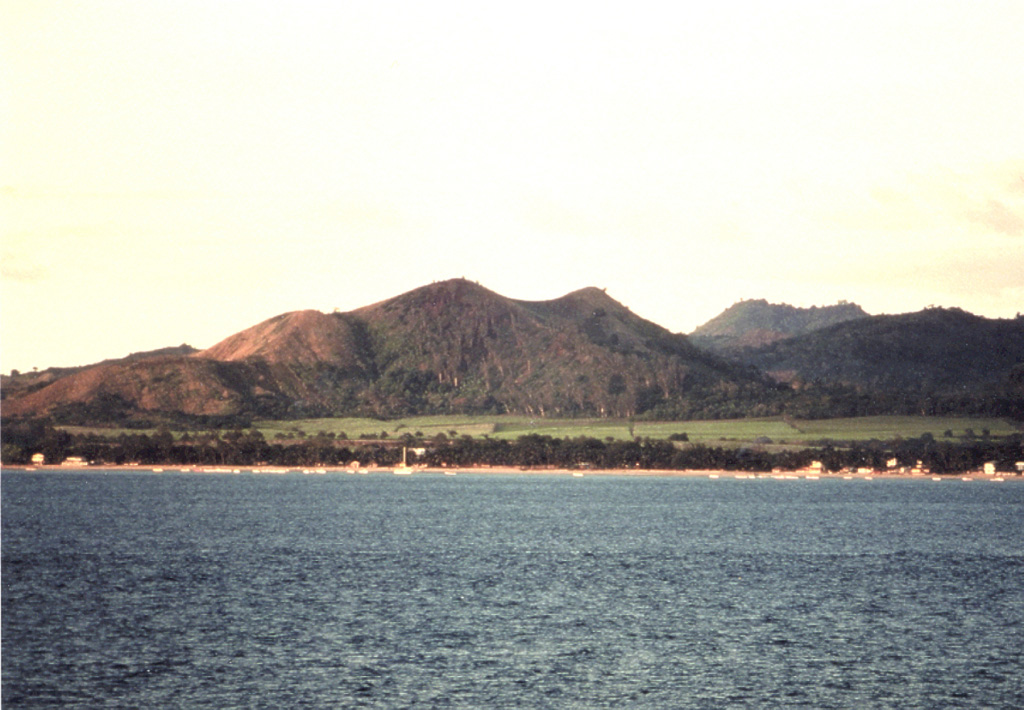 Scoria cones line the shores of Nosy-Be island off the NW coast of Madagascar and have erupted recent basaltic lava flows. Many large crater lakes are found in the central part of the island. The Nosy-Be volcanics overlie Mesozoic limestones and other sedimentary rocks. Two periods of activity occurred, with initial eruptions of fluid lava flows from the W side of the massif followed by the construction of numerous scoria cones on the western plain. Copyrighted photo by Stephen and Donna O'Meara, 2002.