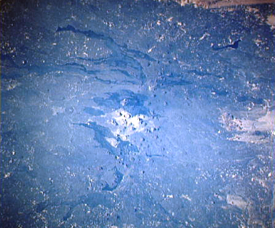 Harrat Khaybar, one of Saudi Arabia's largest volcanic fields, covers an area of more than 14,000 km2 to the N of Madinah (Medina). This Space Shuttle image shows the central vent area of the volcanic field. Light-colored areas at the center of the image show lava domes and tuff rings; above this area is Jabal Qidr volcano. The lava flows extending to the W from the central vent area are young prehistoric and historic. An eruption was reported in early Mohammedan times during the 7th century CE. NASA Space Shuttle image STS38-74-6, 1990 (http://eol.jsc.nasa.gov/).