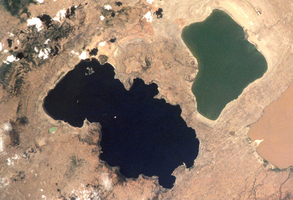 The eastern (right) side of the darker Lake O'a (Lake Shalla) forms the 17-km-wide O'a caldera. Post-caldera activity produced cones N of the caldera. The small light blue-green Chitu maar on the W side of the lake was erupted in an area of Holocene vents along the Corbetti-Shalla fissure system extending N from Corbetti caldera. Fumarolic activity continues along the S and E shores. NASA International Space Station image ISS001-363-7, 2001 (http://eol.jsc.nasa.gov/).