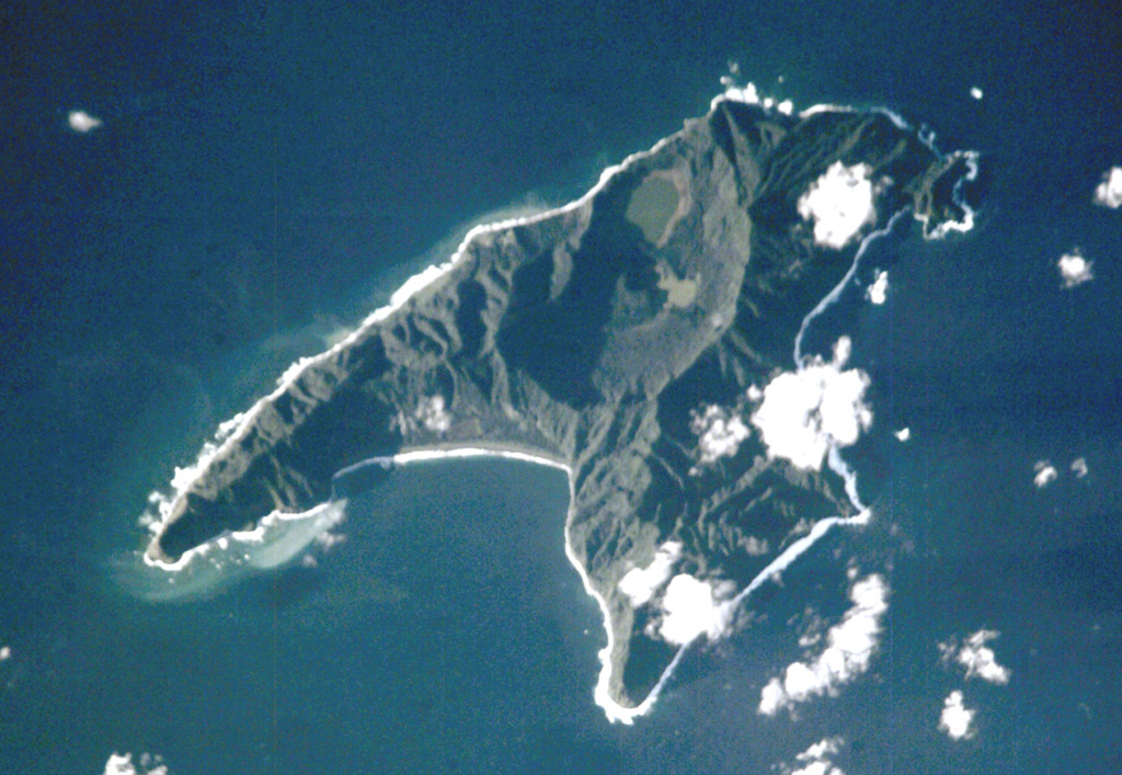 Anvil-shaped Raoul Island is the largest and northernmost of the Kermadec Islands. Two calderas are prominent in this International Space Station view with N to the upper right. The 2.5 x 3.5 km caldera cuts the center of the island, and the E wall of the partially submerged Denham Bay caldera rises above the smooth coastline at the left-center. The 6.5 x 4 km wide Denham Bay caldera formed during a major dacitic explosive eruption about 2,200 years ago, which truncated the W side of the island. NASA International Space Station image ISS002-E-8883, 2001 (http://eol.jsc.nasa.gov/).