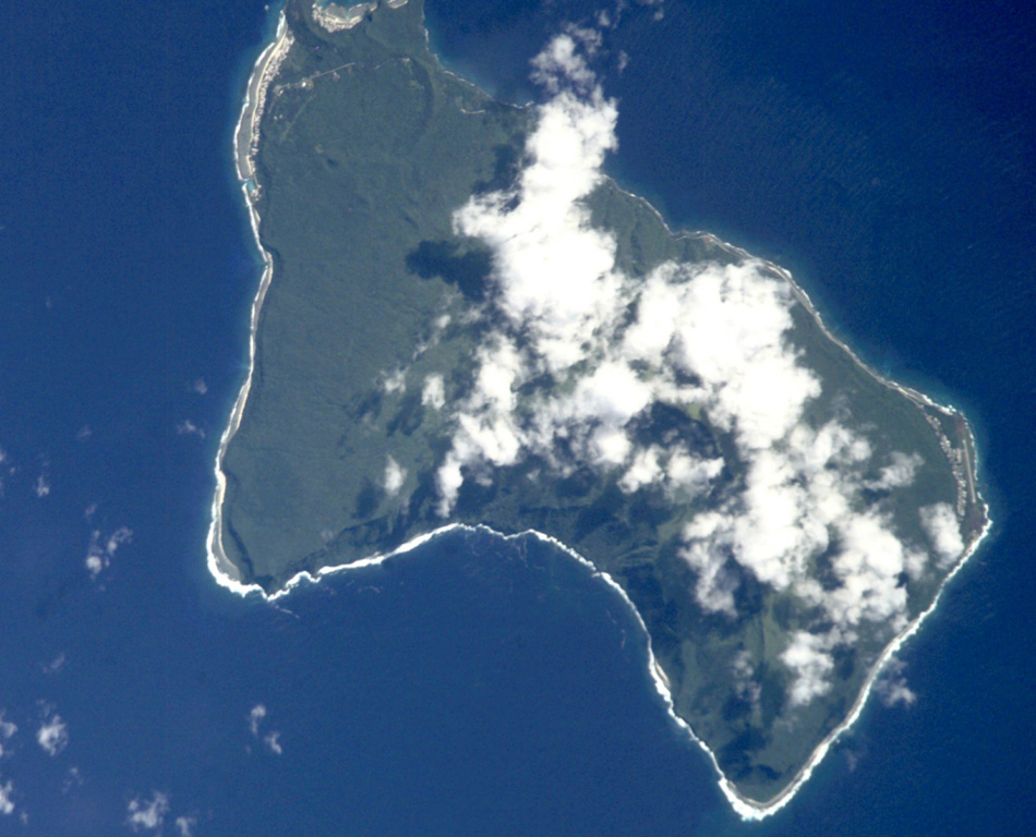 Steep sea cliffs surround the 6 x 10 km Ta'u Island, located at the eastern end of the Samoan islands. The island is the exposed portion of the large Lata shield volcano. Collapse and landslide erosion of the southern portion of the shield volcano have left an arcuate, south-facing embayment (bottom) with a steep headwall. A tuff-cone complex is partially visible at the extreme NW tip of the island (top). The historic village of Fitiiuta lies at the NE tip of the island (far right). NASA International Space Station image ISS002-E-9892, 2001 (http://eol.jsc.nasa.gov/).