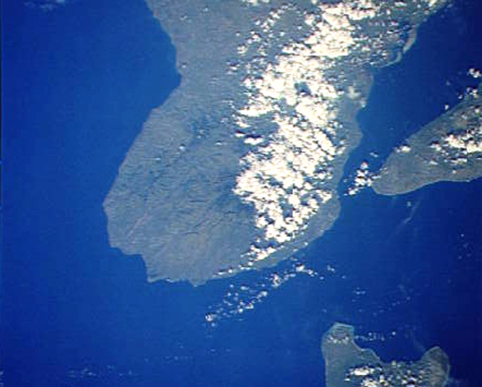 Magaso, also known as Cuernos de Negros, is a large stratovolcano that anchors the SE tip of Negros Island.  The volcano is located just right of center in the cloud-covered portion of SE Negros Island in this Space Shuttle image (with north to the upper right), directly across the channel and in line with the SW tip of Cebu Island at the right side of the image.  No historical eruptions are known from Magaso, but the summit crater is fumarolically active, and the Palinpinon geothermal field are located at its base. NASA Space Shuttle image STS61-40-74, 1985 (http://eol.jsc.nasa.gov/).