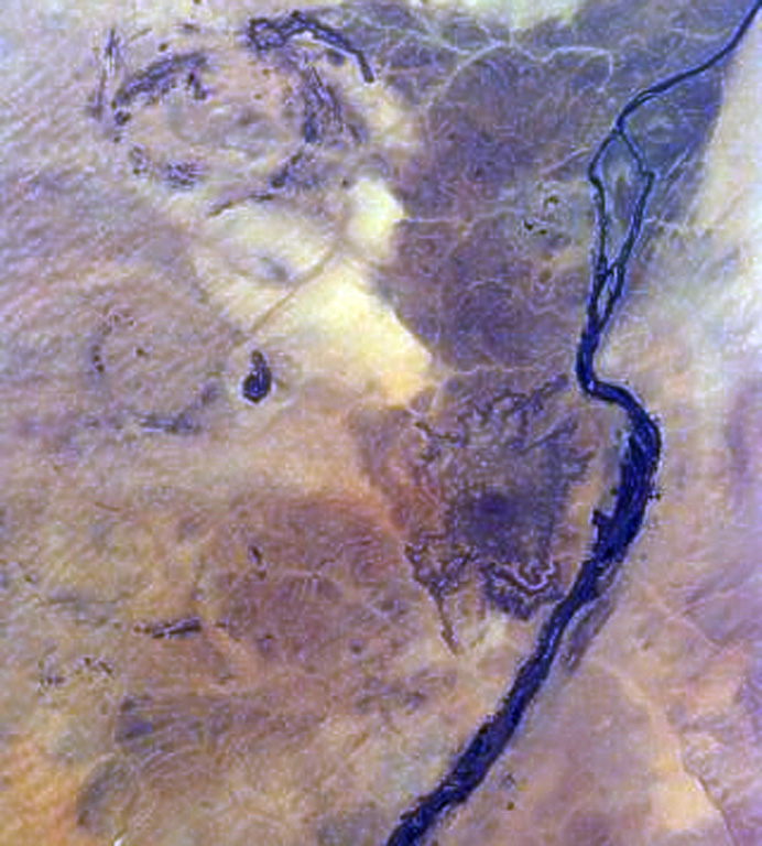 The dark area at right-center to the left of the bend in the Nile River in NE Sudan is the Jebel Umm Arafieb volcanic field, also known as Jebel Umm Marafieb.  Located in the Bayuda Desert NE of the capital city of Khartoum, this volcanic field consists of a low-angle shield volcano formed of several overlapping aa lava flows erupted from a vent now capped by a spatter cone.    NASA Space Shuttle image STS81-ESC-8221240, 1997 (http://eol.jsc.nasa.gov/).