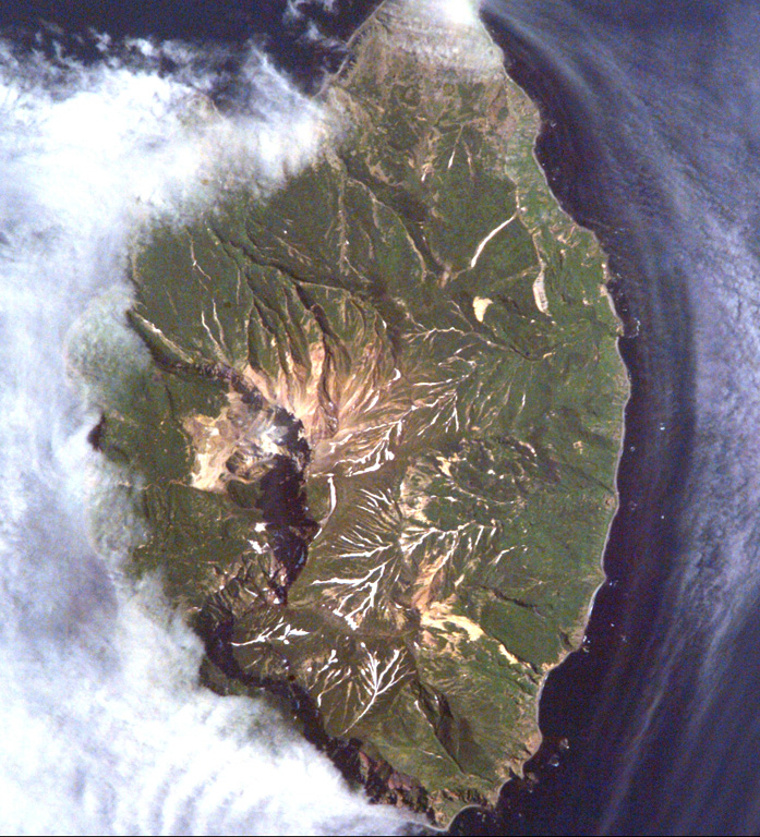 Kuntomintar is a Pleistocene volcano that occupies the southern end of Shiashkotan Island in the central Kurils. A large crater on the west side opens toward the Sea of Okhotsk, with the scarp visible in this International Space Station image (with N to the upper left). NASA International Space Station image ISS005-E-6515, 2002 (http://eol.jsc.nasa.gov/).