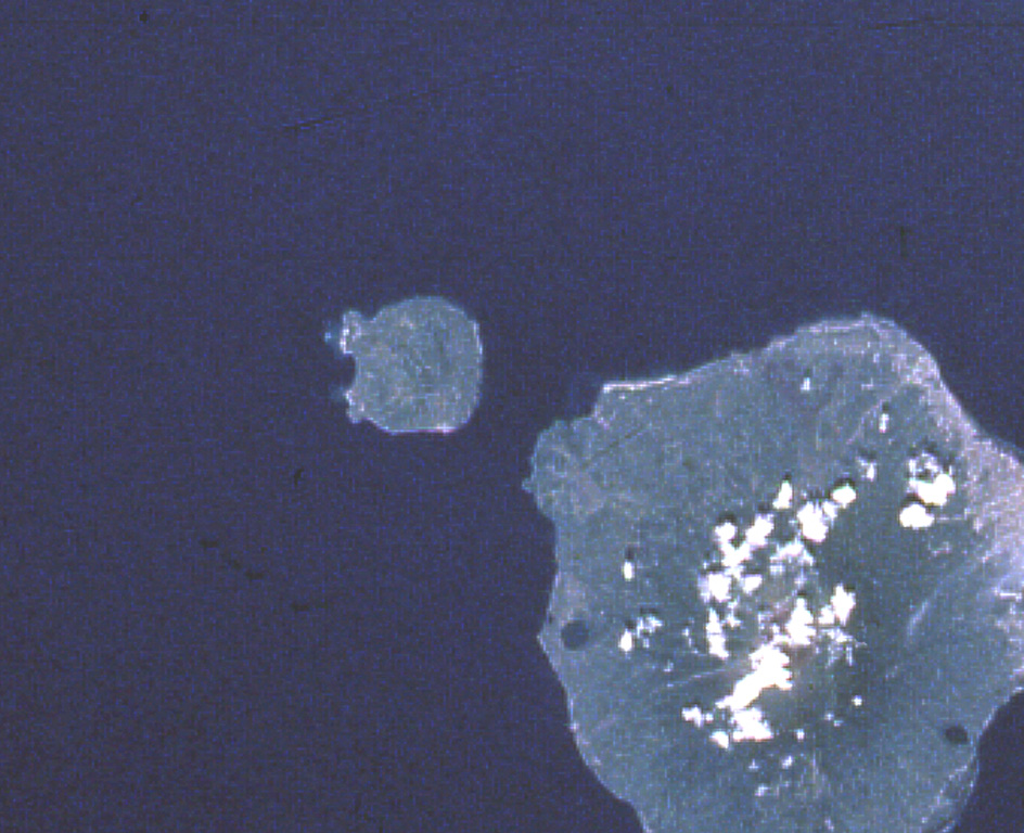 Hiri (left-center), a small 3-km-wide forested island immediately north of Ternate Island (lower right), is the northernmost of a chain of volcanic islands off the western coast of Halmahera.  North is to the upper left in this Space Shuttle image.  Little is known of this volcano, although it was mapped as Holocene in age.  In contrast to Hiri, the better-known Gamalama volcano that forms Ternate Island has been active during historical time, including a 1775 eruption from the small lake-filled maar visible on the NW coast of the island.  NASA Space Shuttle image STS050-99-95, 1992 (http://eol.jsc.nasa.gov/).