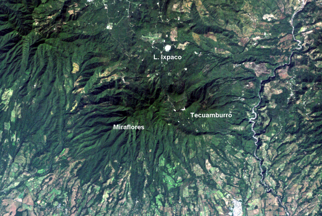 The Tecuamburro volcanic complex has a diverse history. Collapse of the ancestral Pleistocene Miraflores edifice underwent collapse, producing an avalanche deposit that traveled across the Río los Esclavos (right) and forming a large horseshoe-shaped crater open to the east. The modern Tecuamburro complex, consisting of four lava domes, was constructed within this scarp. The Laguna Ixpaco crater was created about 2,900 years ago within the much larger Pleistocene Chupadero crater. NASA Landsat image, 2000 (courtesy of Loren Siebert, University of Akron).