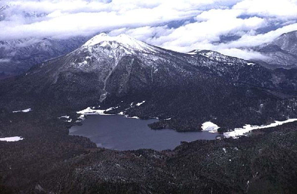 Hiuchigatake rises above Ozenuma lake, seen here from the SE. Two lava domes at the southern end of the summit have been active during the Holocene. The northern dome produced viscous lava flows about 3,500 years ago, and the southern dome was the source of an explosive eruption in 1544 CE. Copyrighted photo by Shun Nakano, 1996 (Japanese Quaternary Volcanoes database, RIODB, http://riodb02.ibase.aist.go.jp/strata/VOL_JP/EN/index.htm and Geol Surv Japan, AIST, http://www.gsj.jp/).