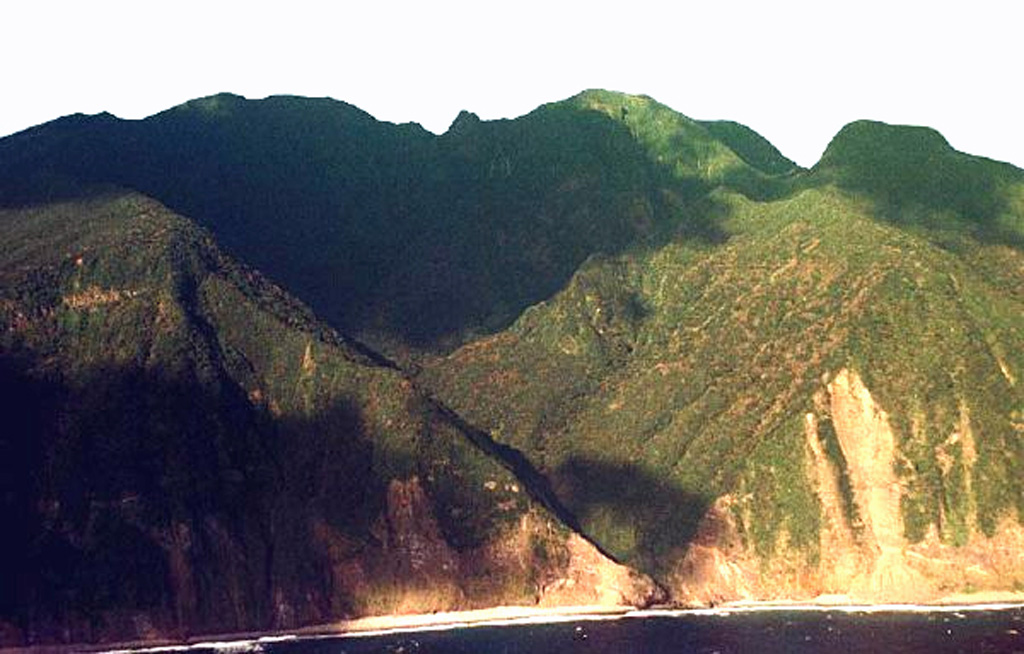 The southern flanks of Mikurajima volcano are seen in this aerial view from the SSW. Oyama, the summit of the island, lies in shadow on the left horizon. The small Ichinomori spire is on the center, while the flat-topped Shipunegamori lava dome is at the far right. Copyrighted photo by Akira Takada (Japanese Quaternary Volcanoes database, RIODB, http://riodb02.ibase.aist.go.jp/strata/VOL_JP/EN/index.htm and Geol Surv Japan, AIST, http://www.gsj.jp/).