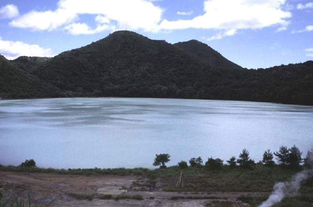 Katanuma lake in the 5.5 x 7 km Narugo caldera is seen from its NW shore with Ogadake lava dome on the right-center horizon. It is the highest of a cluster of lava domes surrounding the lake at 470 m above sea level. Katanuma is one of the most acidic crater lakes in Japan, with a pH of 1.6, and sulfur is mined from sediments on the lake floor. Copyrighted photo by Jun'ichi Itoh (Japanese Quaternary Volcanoes database, RIODB, http://riodb02.ibase.aist.go.jp/strata/VOL_JP/EN/index.htm and Geol Surv Japan, AIST, http://www.gsj.jp/).