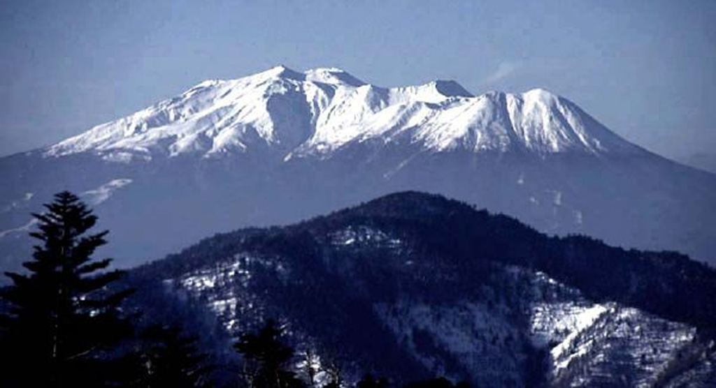 Ontake volcano is seen here from the NE with the Kengamine summit peak near the center. The broad summit contains a series of small craters along a NNE-trend. The first recorded eruption was in 1979. Copyrighted photo by Shun Nakano (Japanese Quaternary Volcanoes database, RIODB, http://riodb02.ibase.aist.go.jp/strata/VOL_JP/EN/index.htm and Geol Surv Japan, AIST, http://www.gsj.jp/).