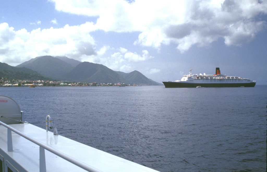 Volcano eco-tourism is a major component of the economy of the island of Dominica.  The cruise ship Queen Elizabeth II anchors in Roseau harbor with Morne Plat Pays volcano in the background.  The Valley of Desolation thermal area is a popular destination for island visitors. Photo by Lee Siebert, 2002 (Smithsonian Institution).