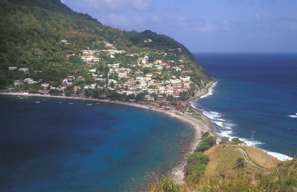 A narrow sand-and-gravel bar connects the picturesque fishing village of Scotts Head, the southernmost on Dominica, to the Scotts Head lava dome.  The village, also known as Cachacrou, overlies volcaniclastic deposits on the SW flank of Crabier lava dome, a post-caldera dome near the southern rim of the Morne Plat Pays caldera. Photo by Lee Siebert, 2002 (Smithsonian Institution).