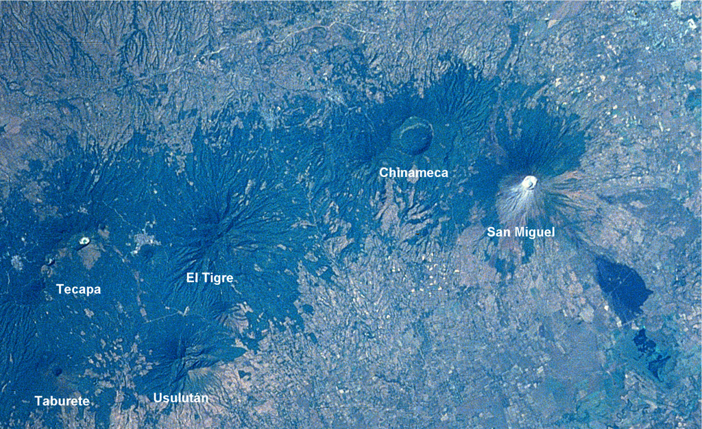 An E-W-trending chain of volcanoes extends about30 km across eastern El Salvador. The 2-km-wide Laguna Seca el Pacayal caldera is a prominent feature of Chinameca volcano. San Miguel is one of El Salvador's most active volcanoes; the dark area at the lower right is a lava flow from the 1819 eruption. The city of San Miguel is to the upper right. NASA Space Shuttle image STS61C-31-47, 1986 (http://eol.jsc.nasa.gov/).
