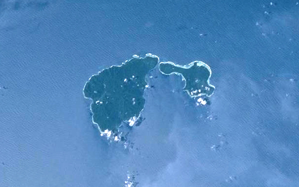 Ambitle (left center) is the larger of two adjacent islands forming the Feni Islands. The 13-km-long island is dominantly Pliocene-to-Pleistocene with a 3-km-wide central caldera. A maar on the E side of post-caldera lava domes formed about 2,300 years ago. Thermal areas are active within the caldera and just off the W coast. Babase Island, immediately to the NE of Ambitle, is a Pleistocene volcano and lava dome connected by a narrow isthmus. NASA Space Shuttle image STS88-706-56, 1998 (http://eol.jsc.nasa.gov/).